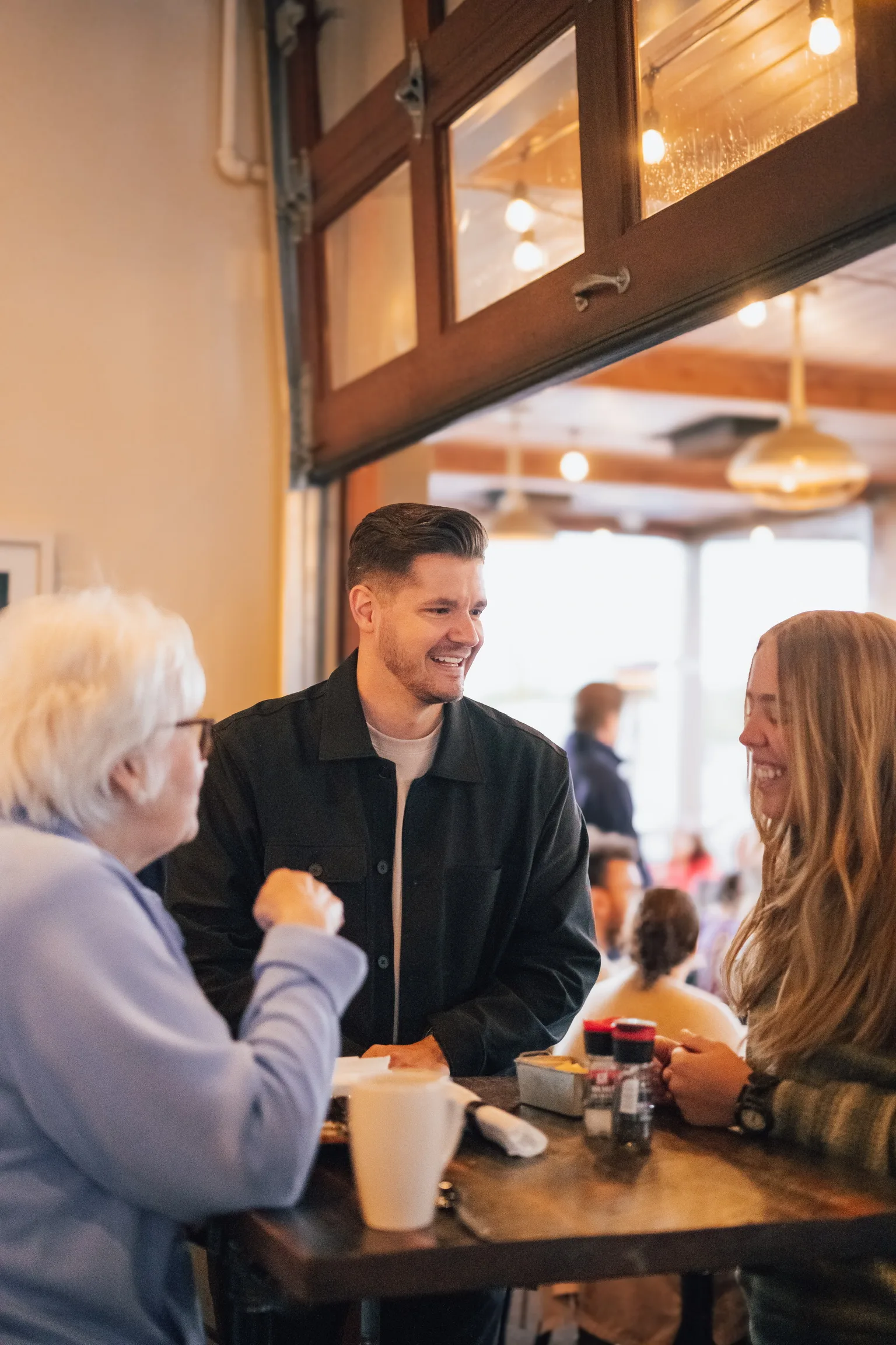 Friends talking over coffee at Living Springs